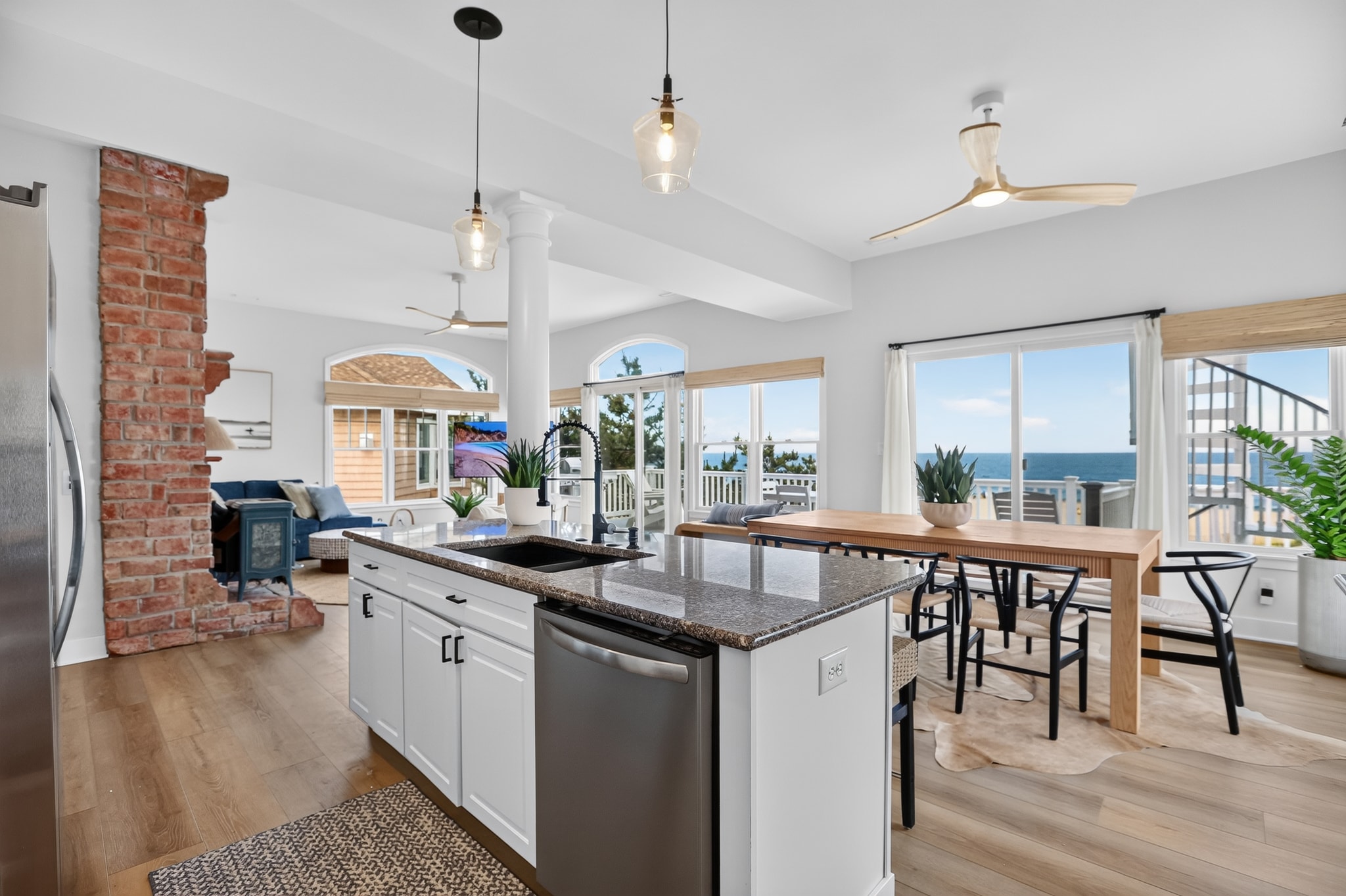 Renovated kitchen with island, granite counters and ocean views