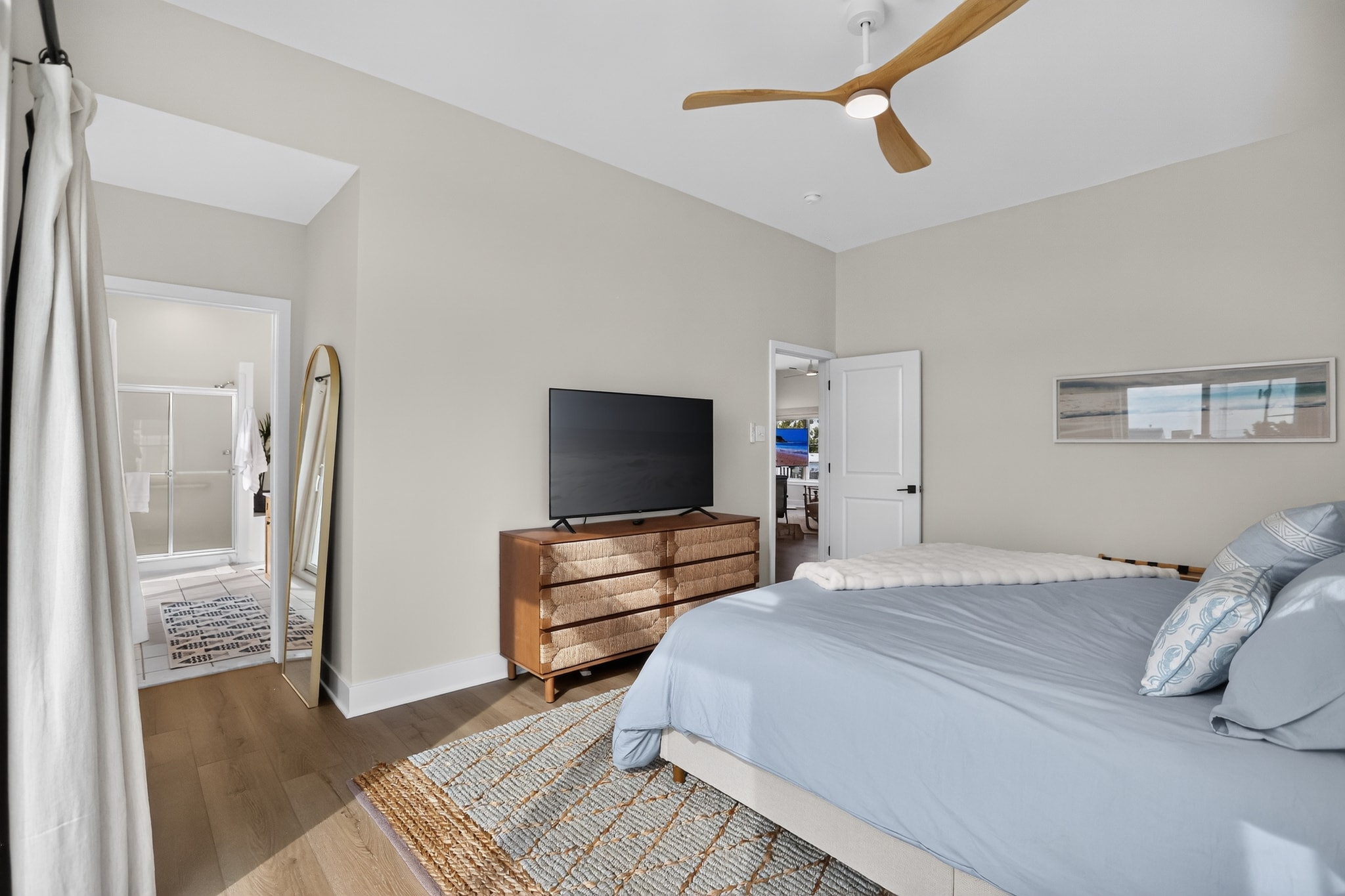 King bedroom with en-suite bath and coastal decor