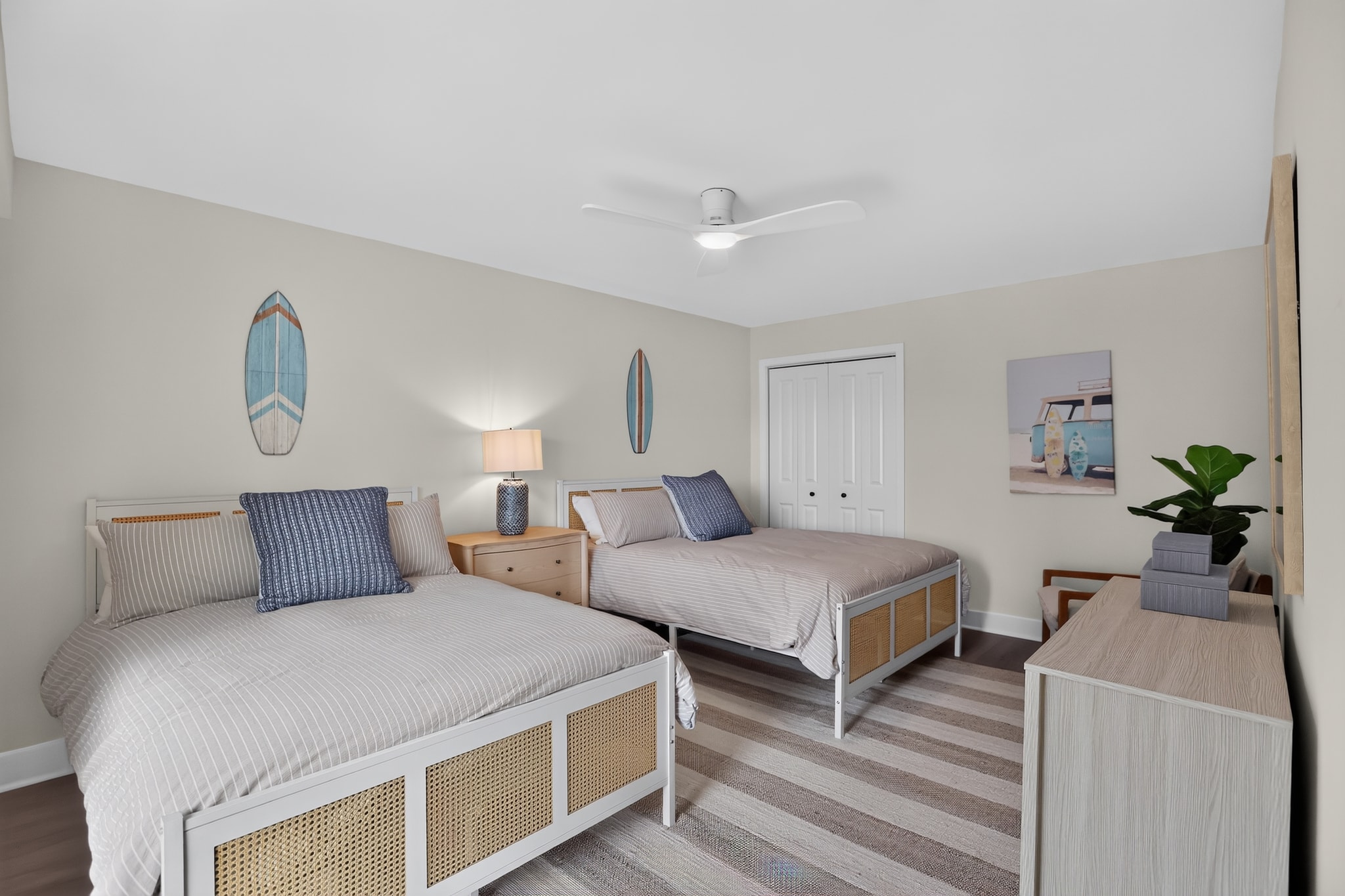 Guest bedroom with two beds and surf decor