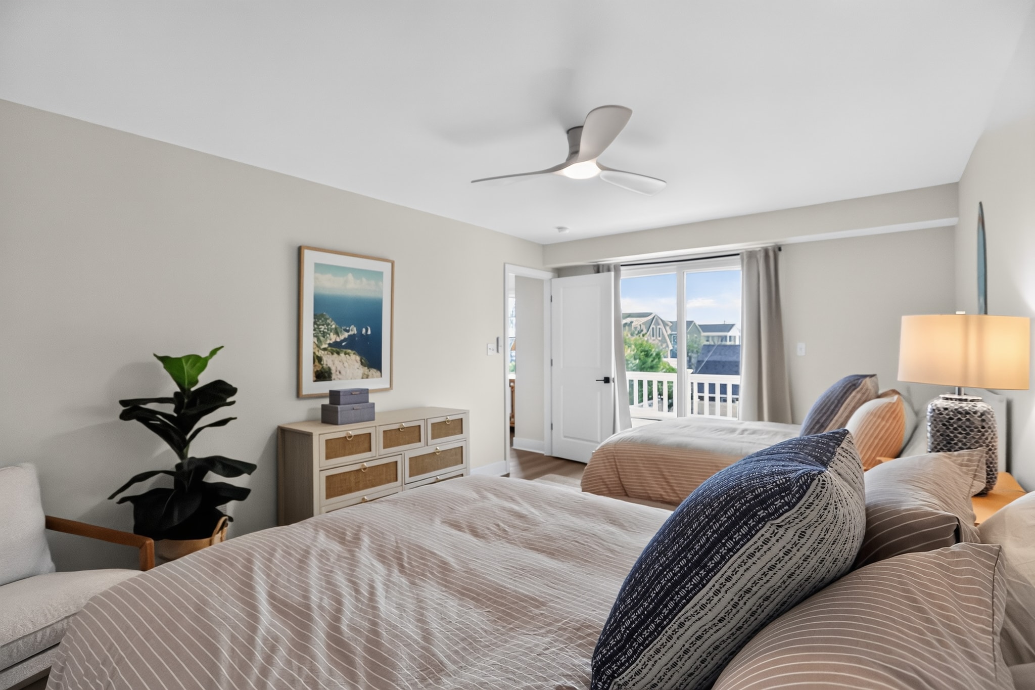 Guest bedroom with two beds and deck access