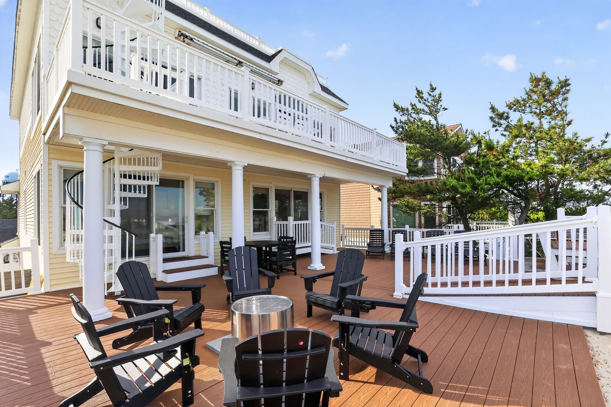 Large deck with Adirondack chairs and fire pit