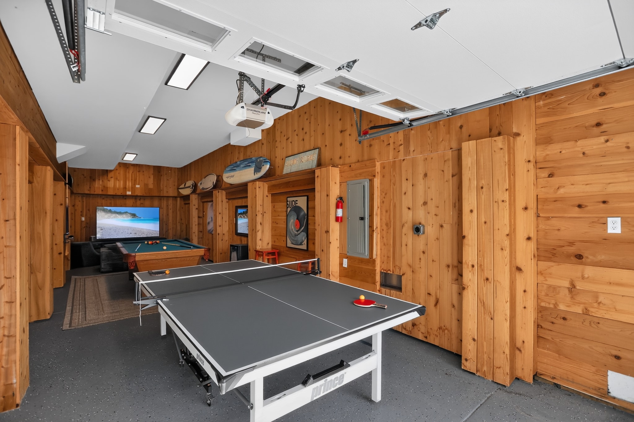 Game room with ping pong table, pool table and large TV