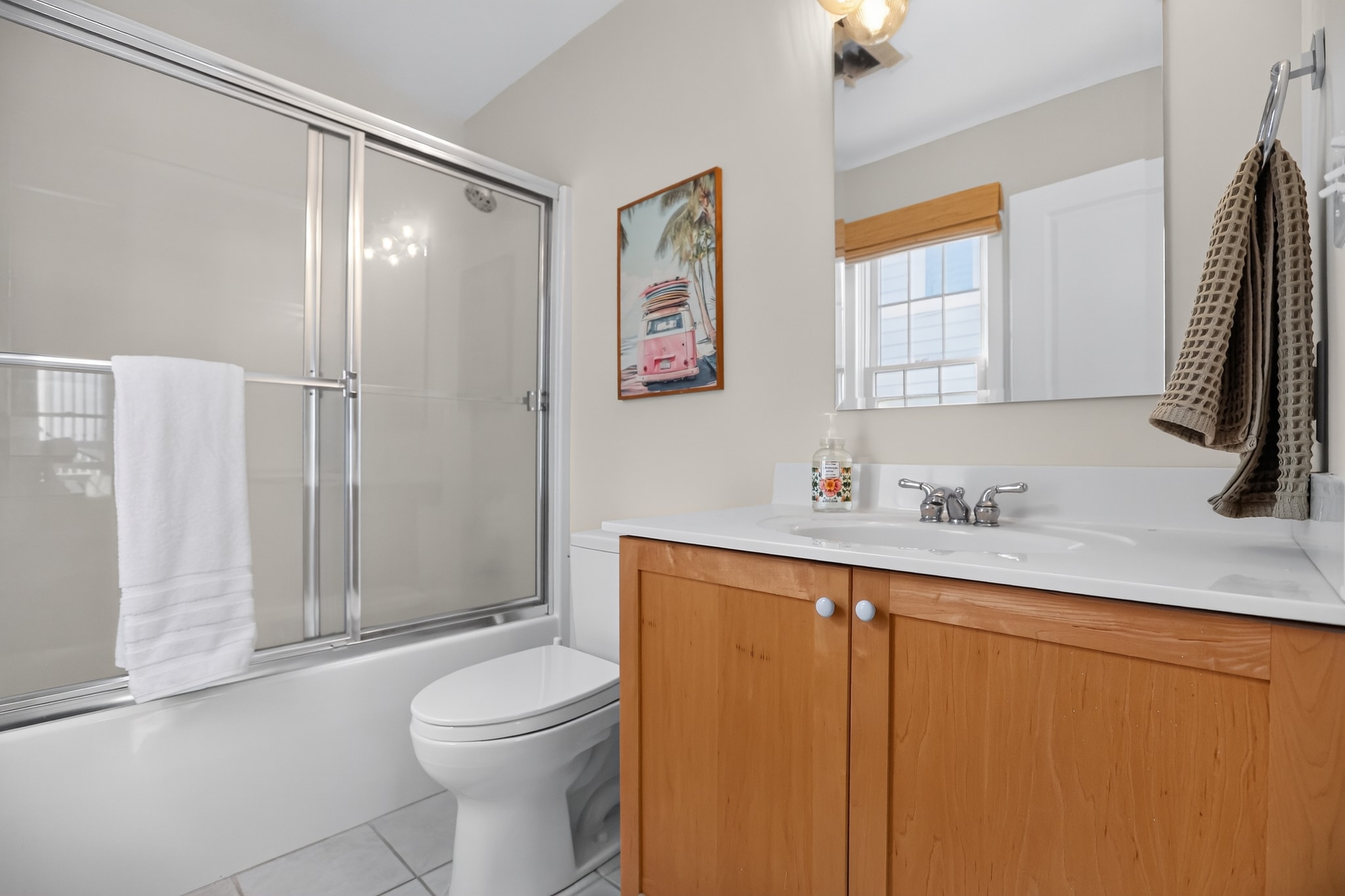 Bathroom with tub, shower and coastal surf decor