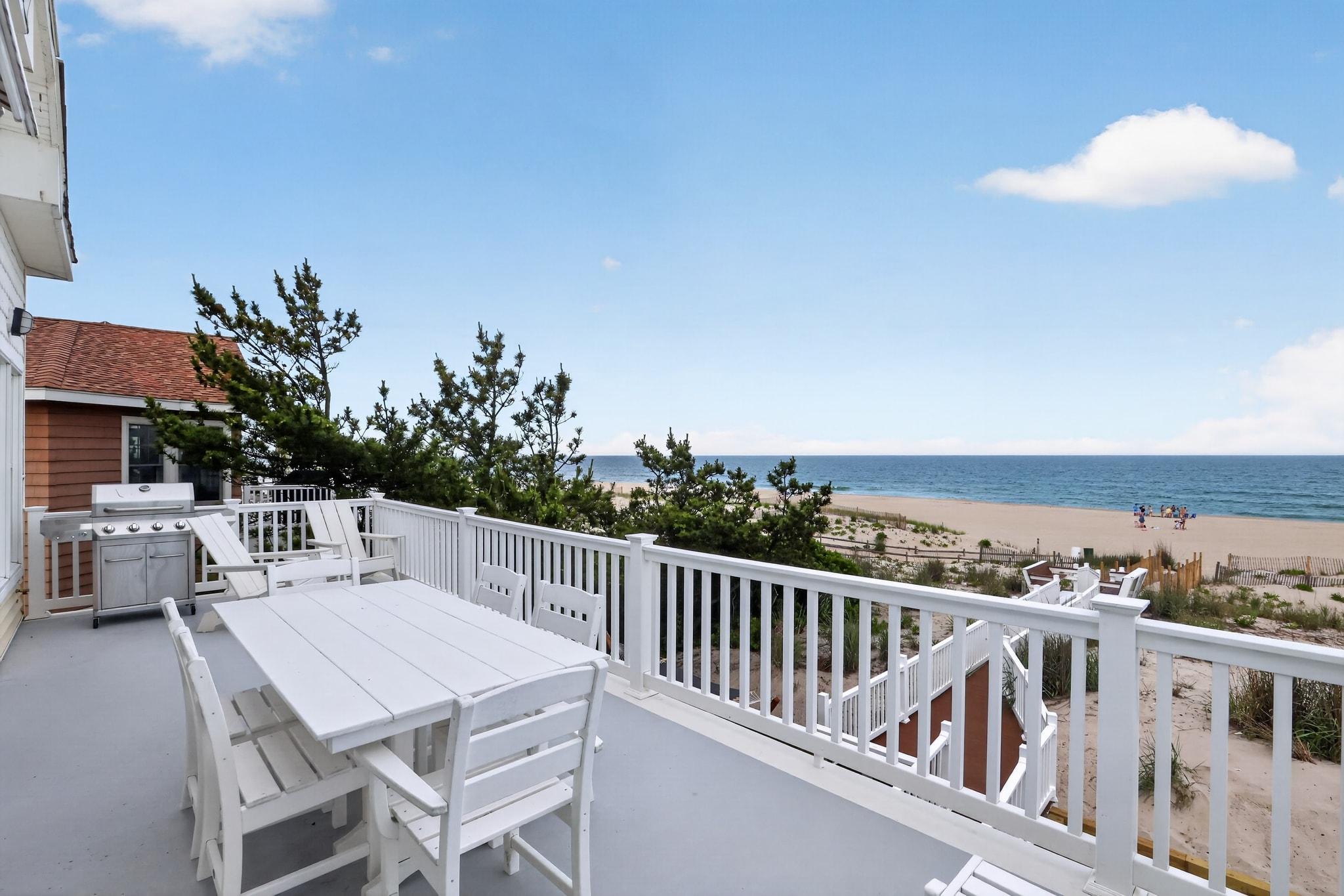 Oceanfront deck with dining table and grill