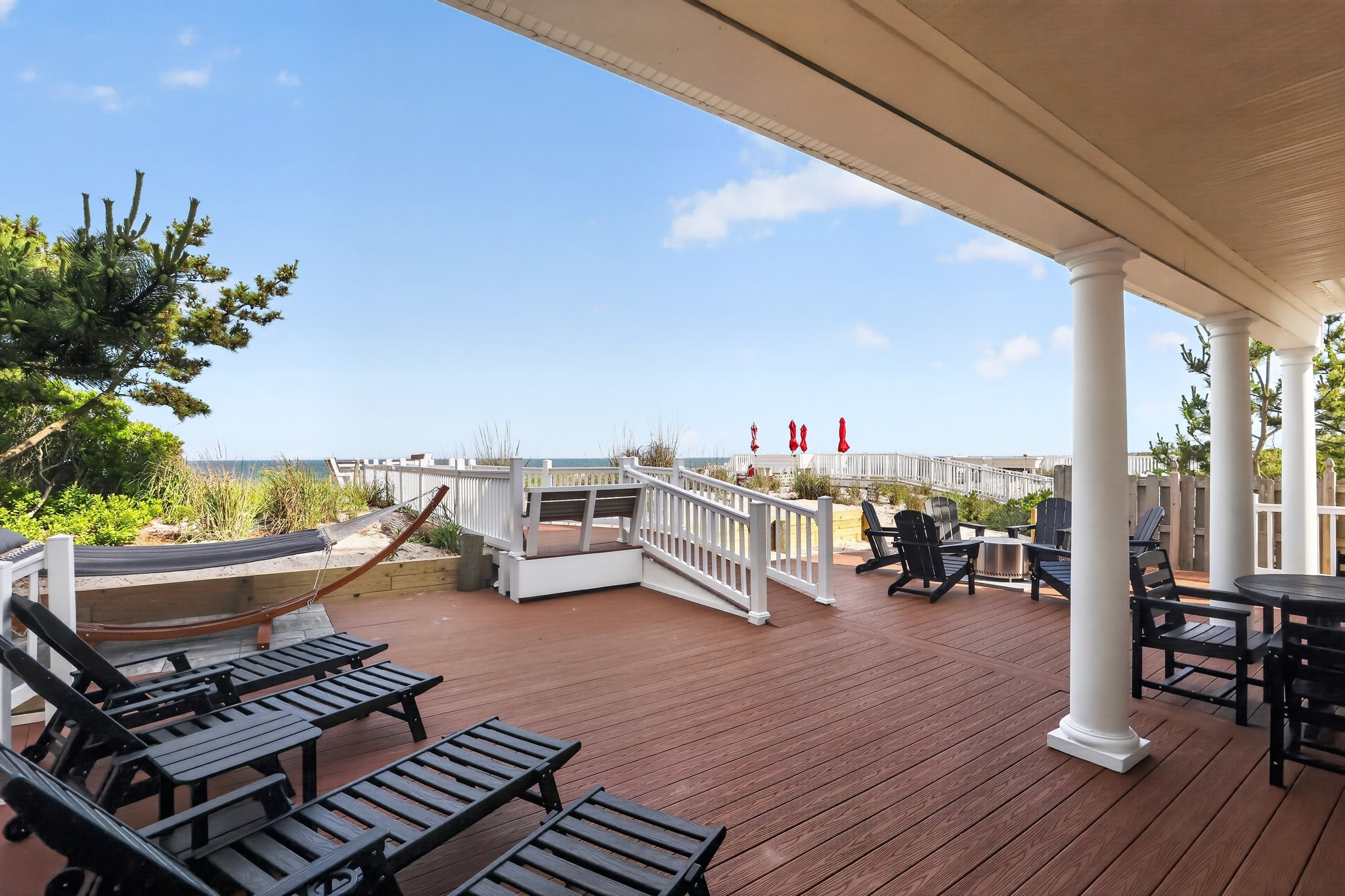 Covered deck with lounge chairs and ocean view