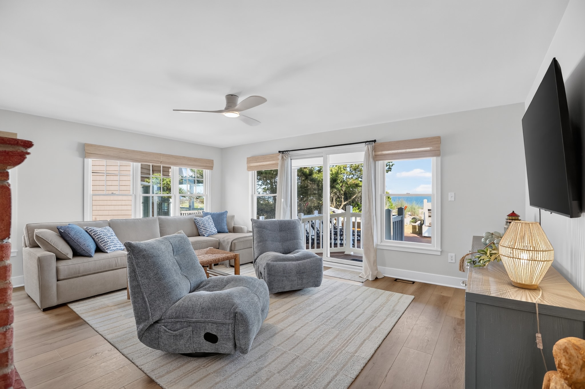 Bright living room with ocean views and fireplace